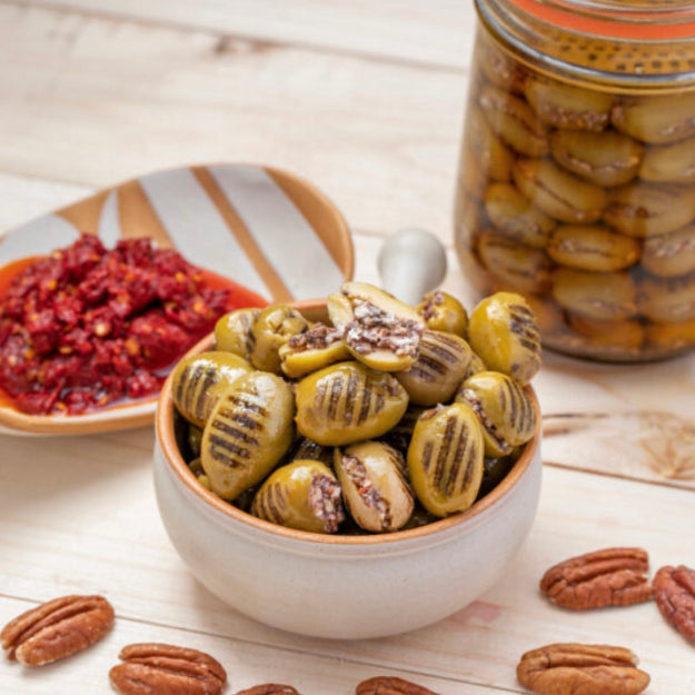 Grilled olives stuffed with walnuts and hot pepper