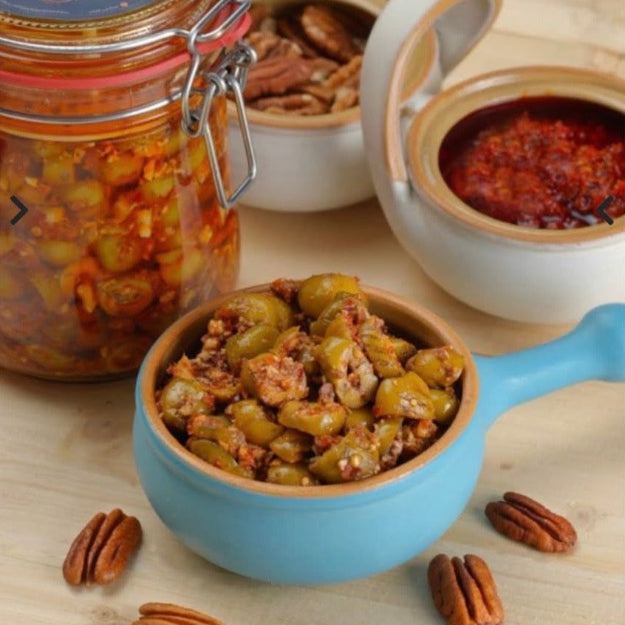 Grilled olive salad with walnuts and chili slices